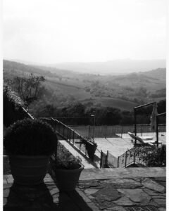 A black and white landscape view of Rosewood Castiglion del Bosco, highlighting its timeless charm and Tuscan beauty.