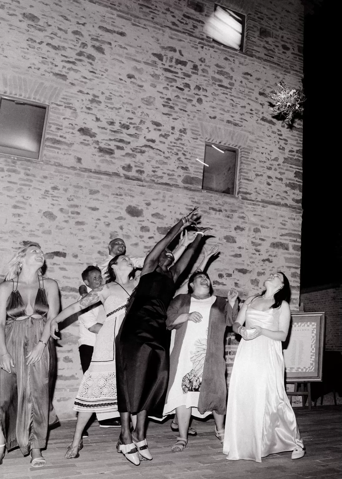 Fun bouquet toss with excited guests during Casa Olivi wedding celebration