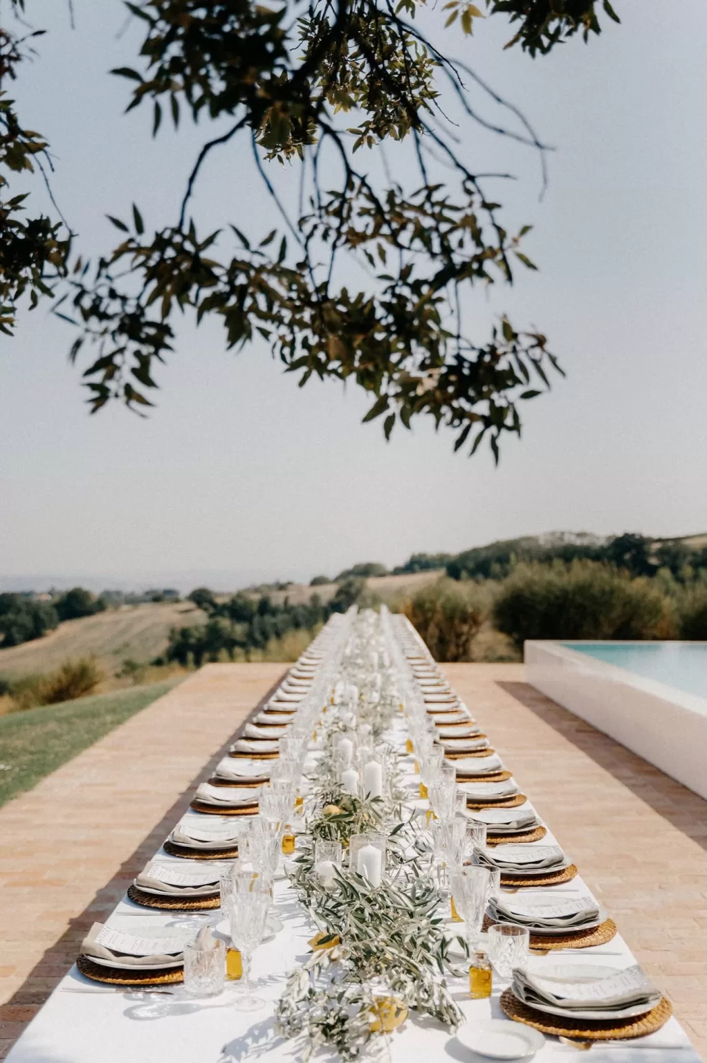 Elegant long outdoor wedding reception table at Casa Olivi with countryside views