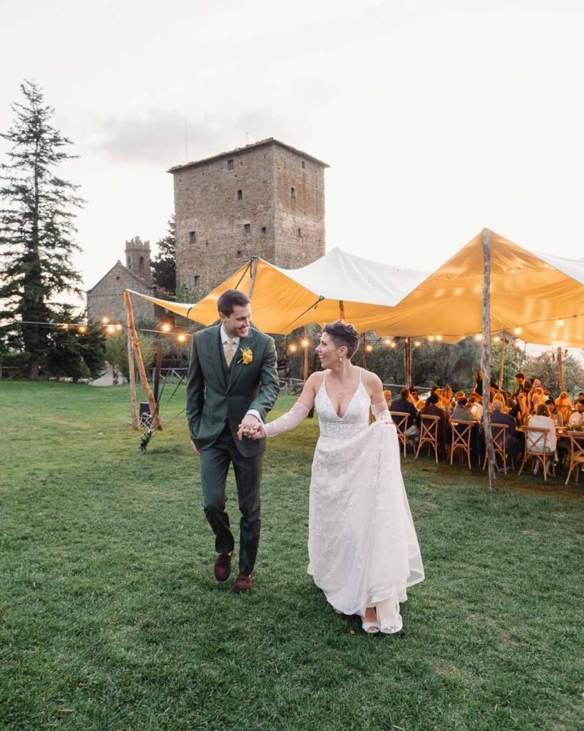 Romantic wedding ceremony in the stone courtyard of Castello di Ristonchi, surrounded by Tuscan countryside. Captured by Wild Silk Visuals.