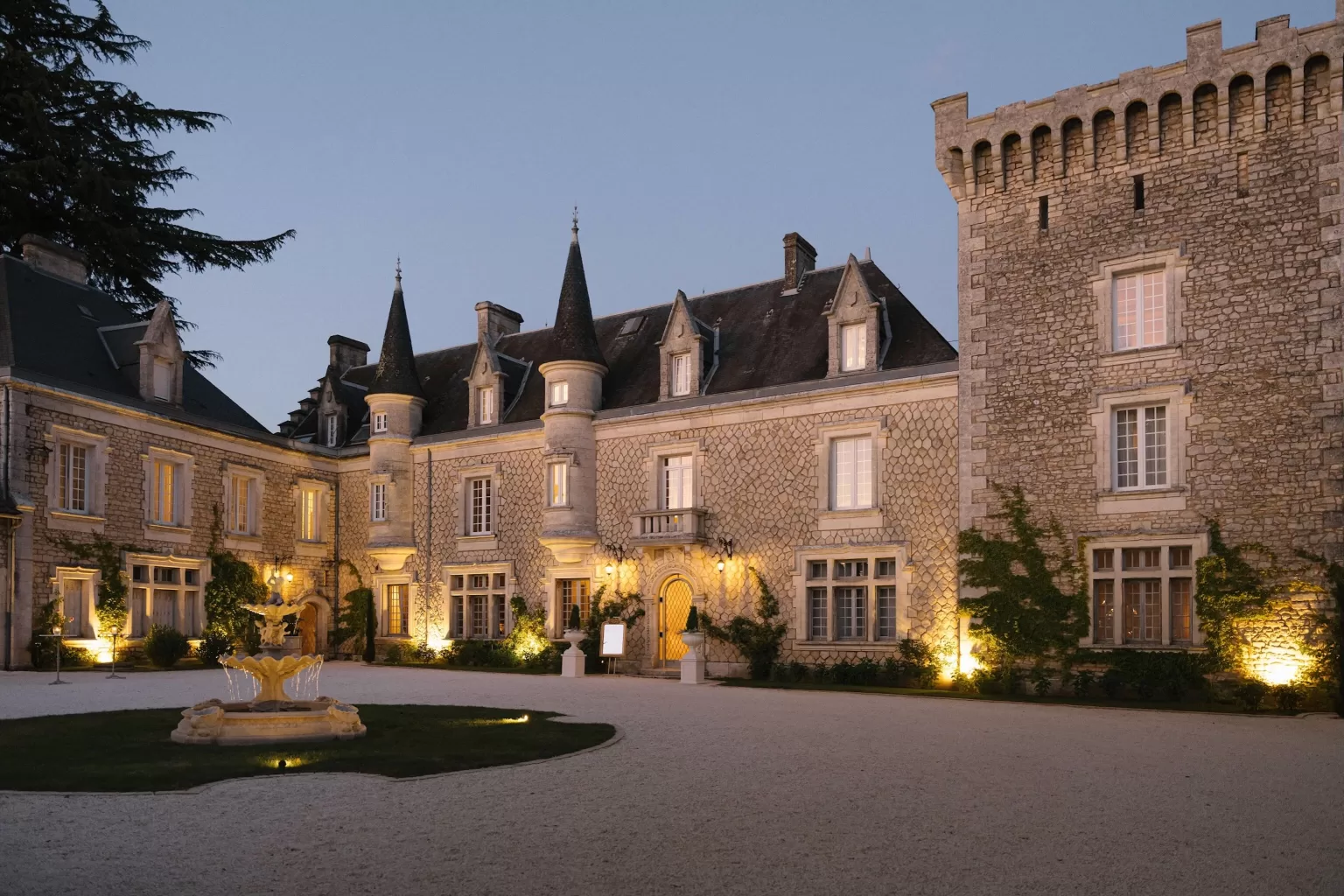Château de la Couronne illuminated with warm evening lighting.