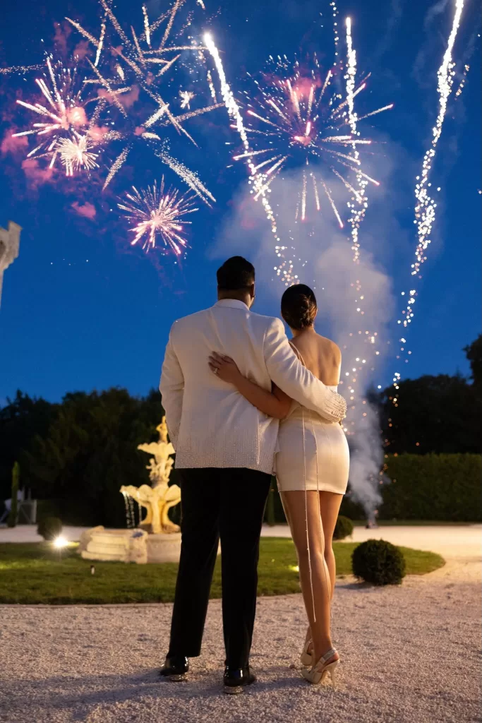 Couple watching a magical wedding fireworks display at Château de la Couronne.