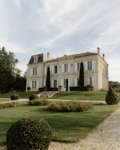 Front facade of Chateau de Garde in France with elegant stone architecture.