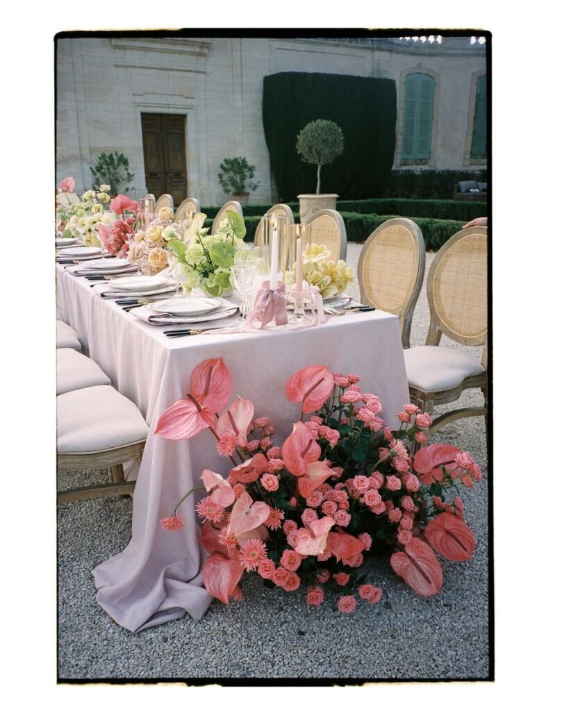 A detailed shot of the wedding tablescape at Chateau de Tourreau, featuring gold accents, floral centerpieces, and elegant tableware.