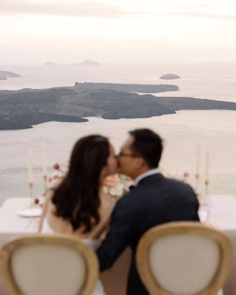 Bride and groom celebrating their elopement with stunning views from Cocoon Suites, Santorini