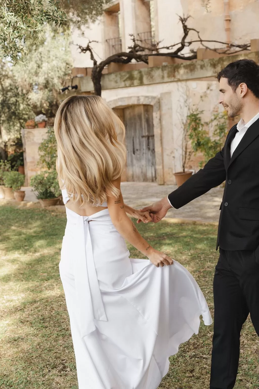Bride twirling playfully with groom in the garden of Finca Son Sampol.