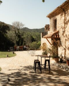 Welcoming entrance to Mas del Sord, framed by historic stone walls and Mediterranean foliage.