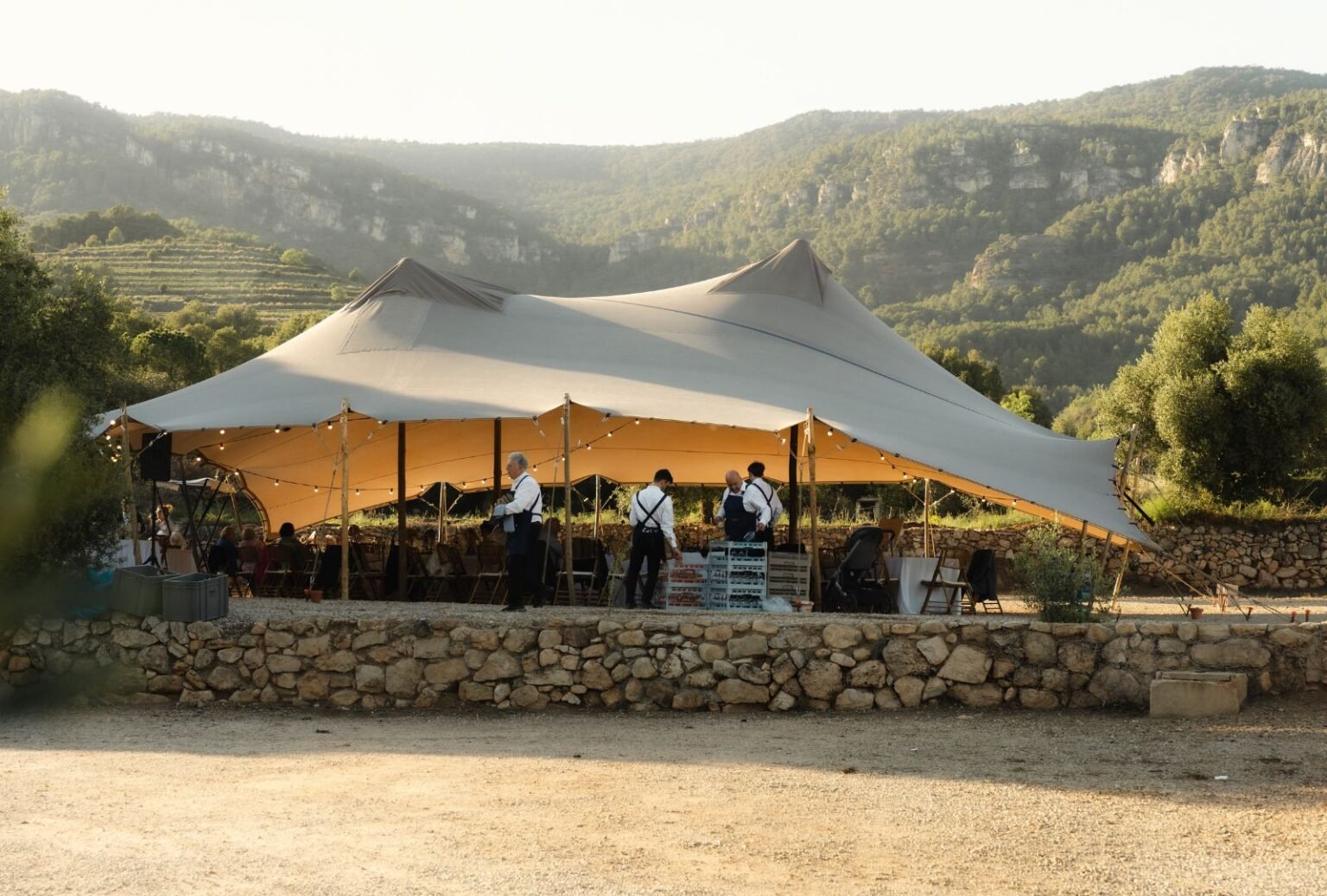 Elegant reception tent at Mas del Sord, draped with soft fabric and adorned with twinkling string lights for a magical evening celebration.