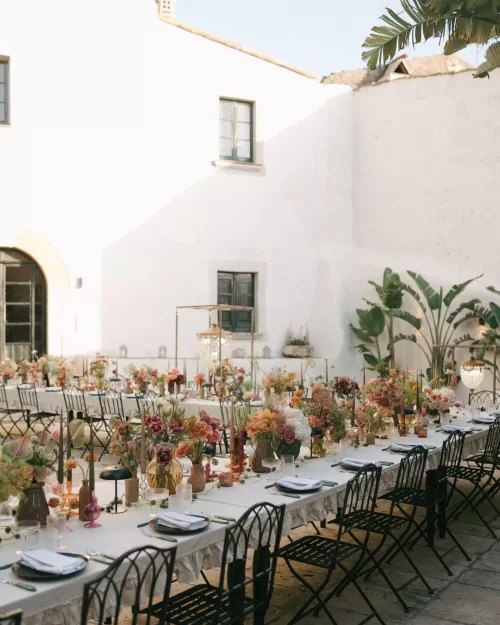 A wedding dinner table at Masia Victoria styled with greenery, soft candles, and sophisticated table settings.