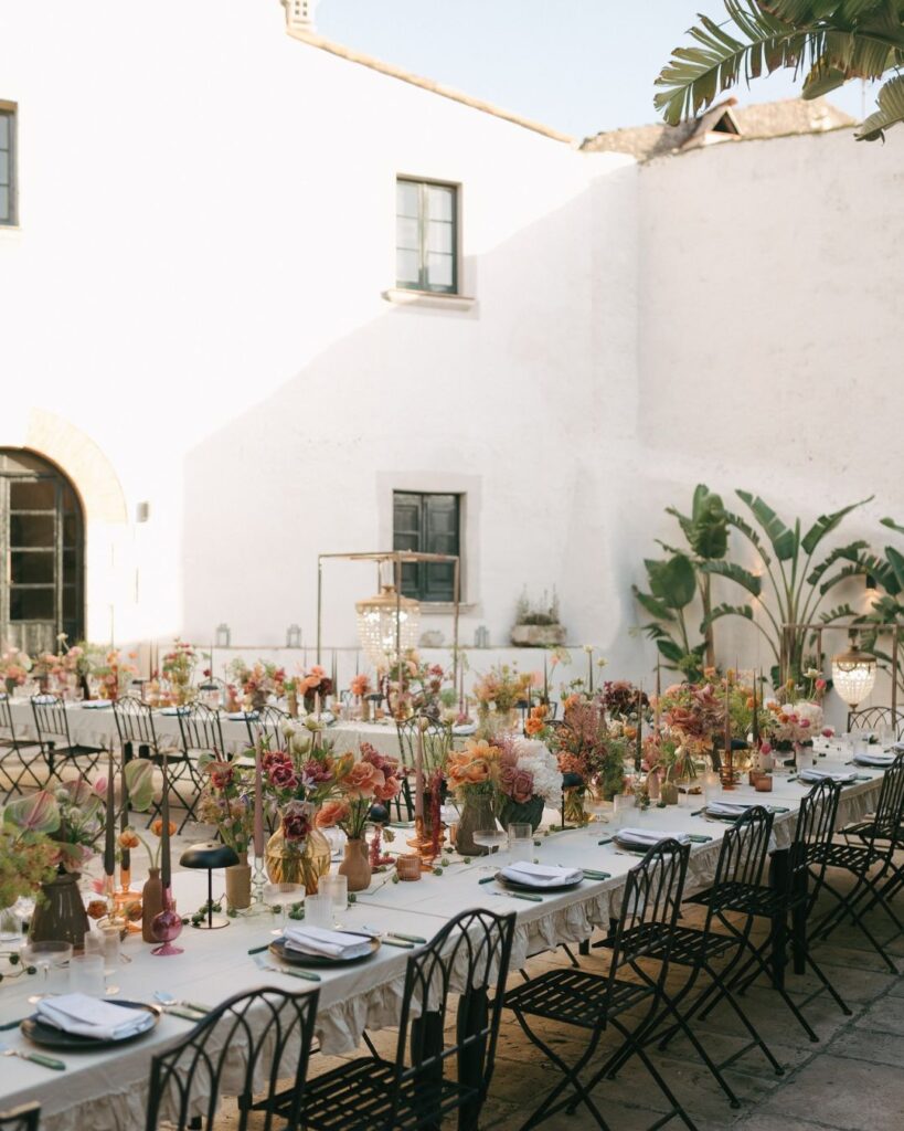 A wedding dinner table at Masia Victoria styled with greenery, soft candles, and sophisticated table settings.
