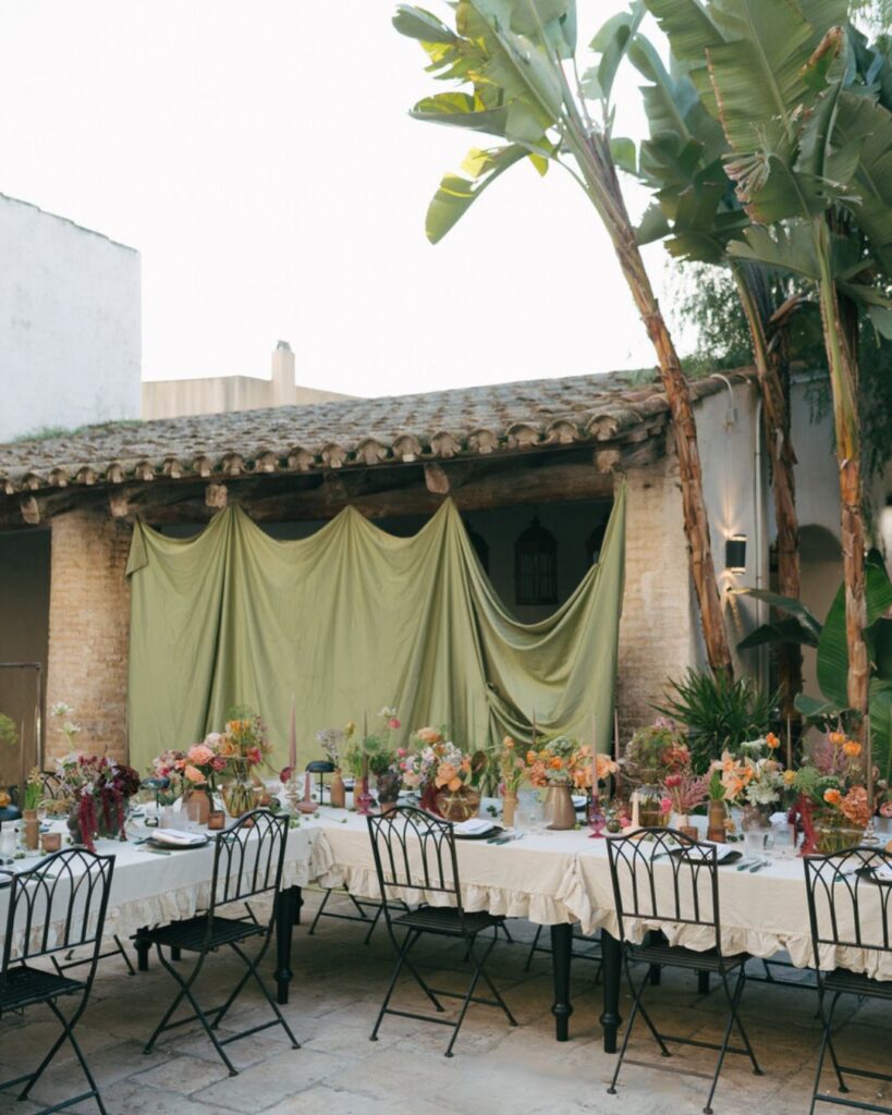 A wedding table setup at Masia Victoria featuring gold cutlery, elegant glassware, and a floral centerpiece for a refined look.