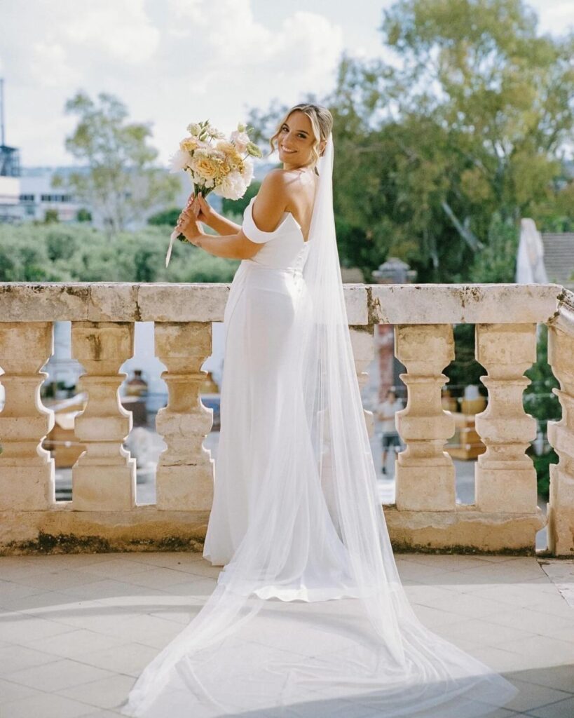 Elegant wedding ceremony setup at Masseria Spina, featuring rustic chairs and floral arrangements under the Mediterranean sun, captured by Amali Studios.