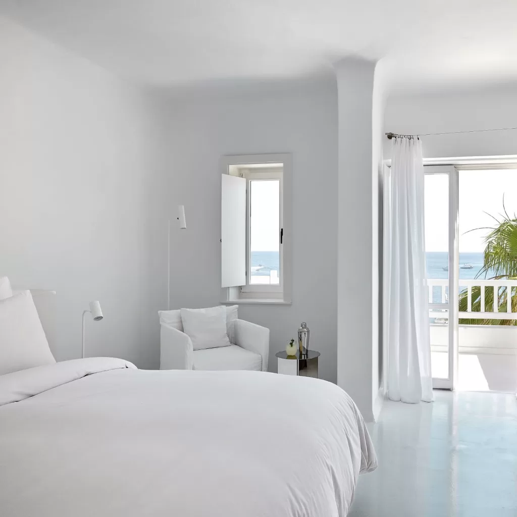 Tranquil sea view framed by the whitewashed interiors of a luxury suite at Mykonos Blu.