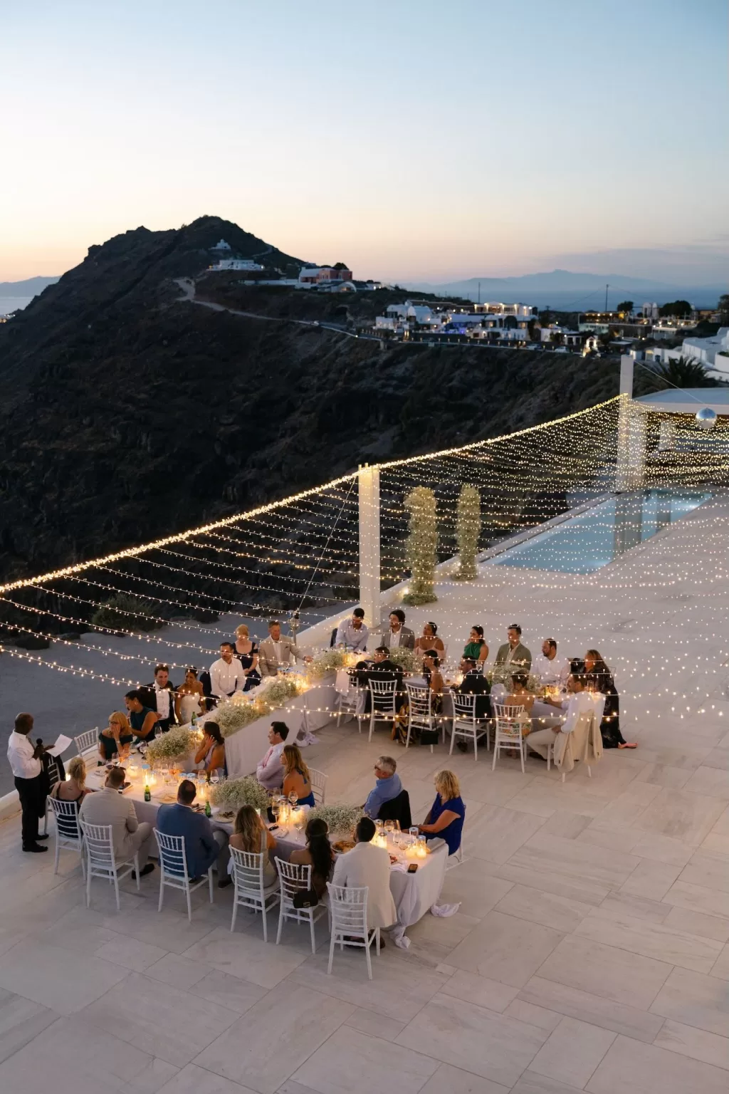 Magical evening reception under string lights at Rocabella Santorini