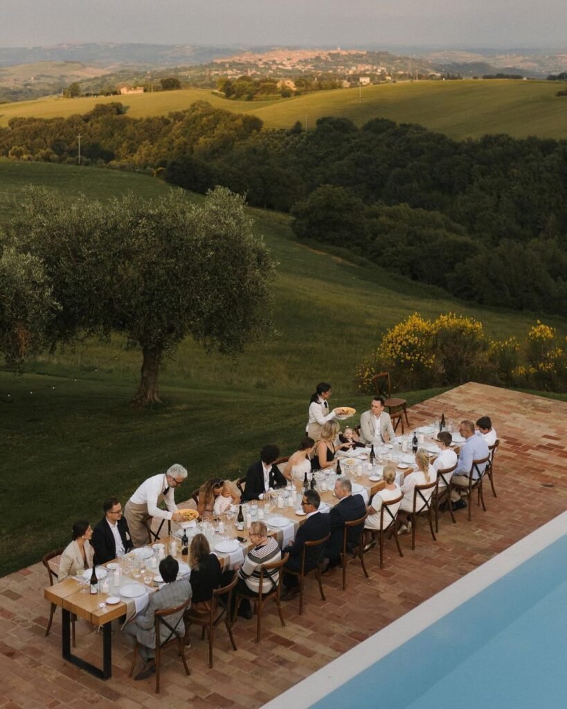 Intimate reception dining area adorned with floral arrangements and candles at Casa Olivi, beautifully captured by Nastuniema.