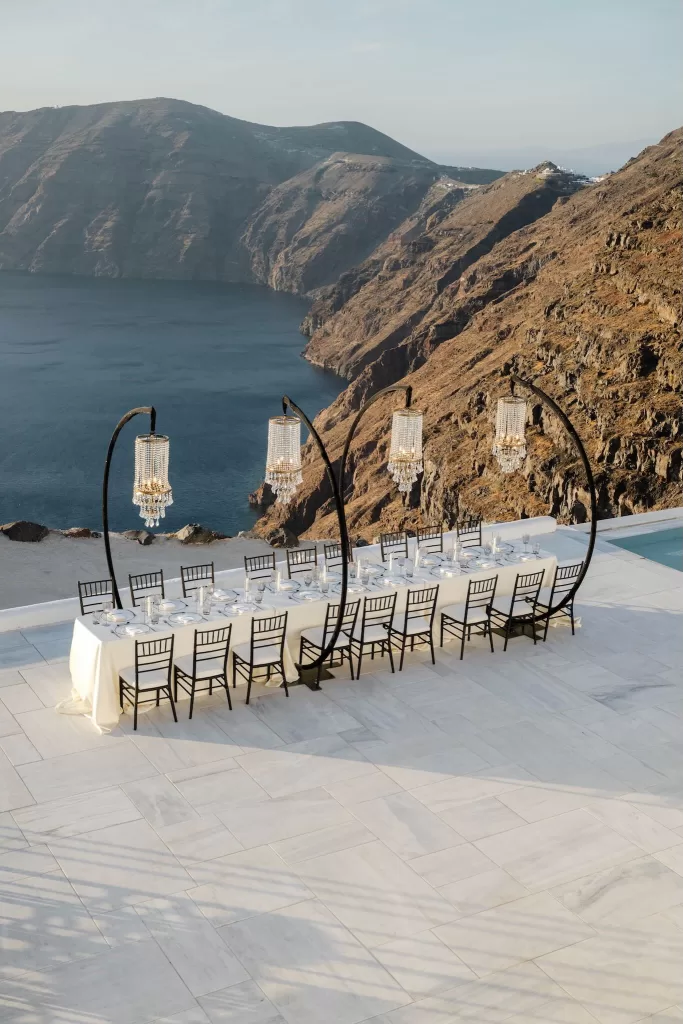 Cliffside wedding dining setup with ocean views at Rocabella Santorini
