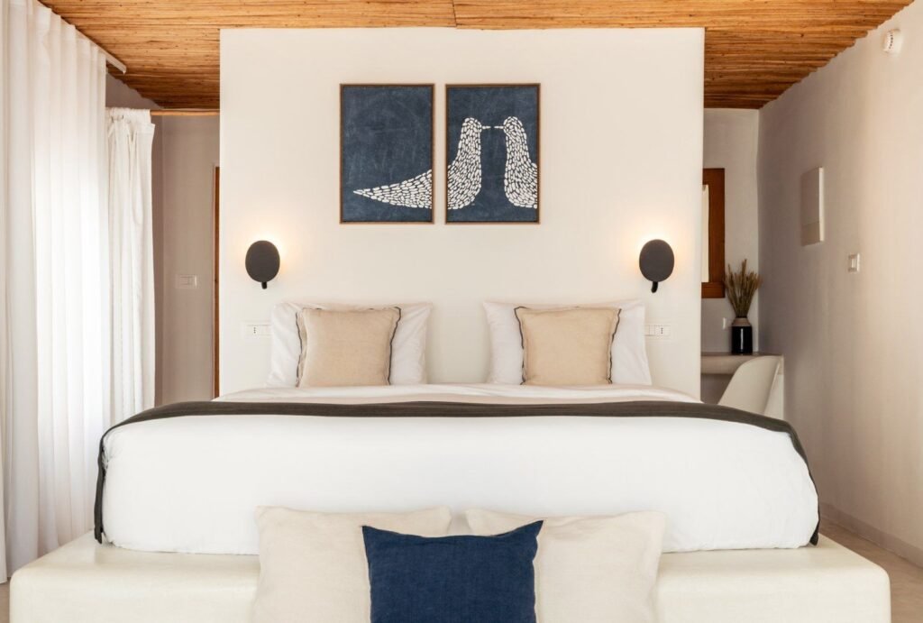 Interior of a luxury suite at Rocabella Santorini, offering modern amenities and stunning views for wedding guests.