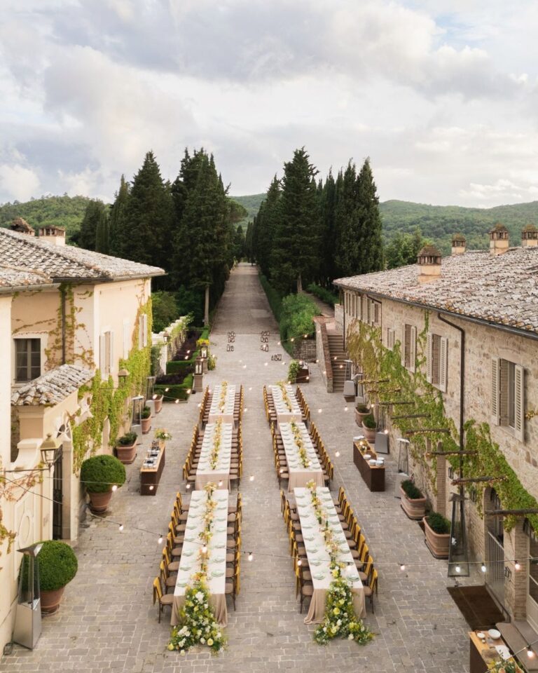 A wedding dinner table with a breathtaking view of the Tuscan countryside at Rosewood Castiglion del Bosco.