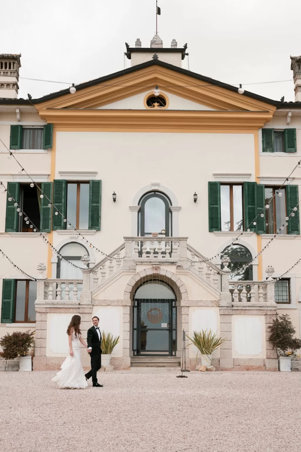Bride and groom walking hand in hand outside the villa at Rustico Bertel.