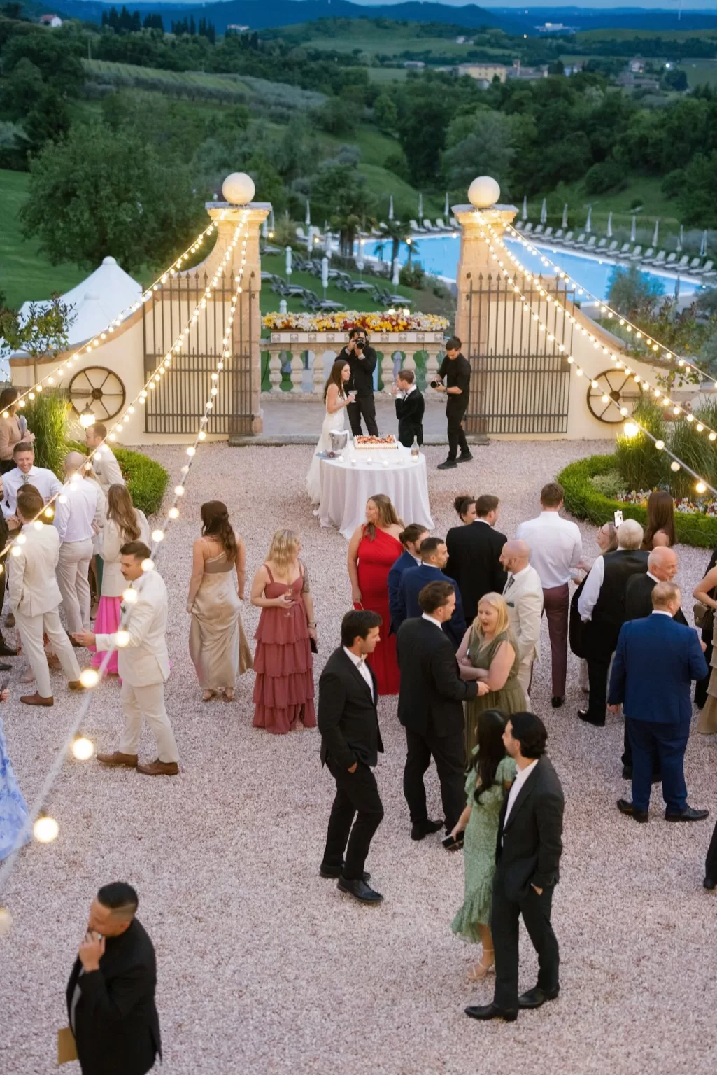 Guests mingling under string lights in the courtyard of Rustico Bertel during cocktail hour.