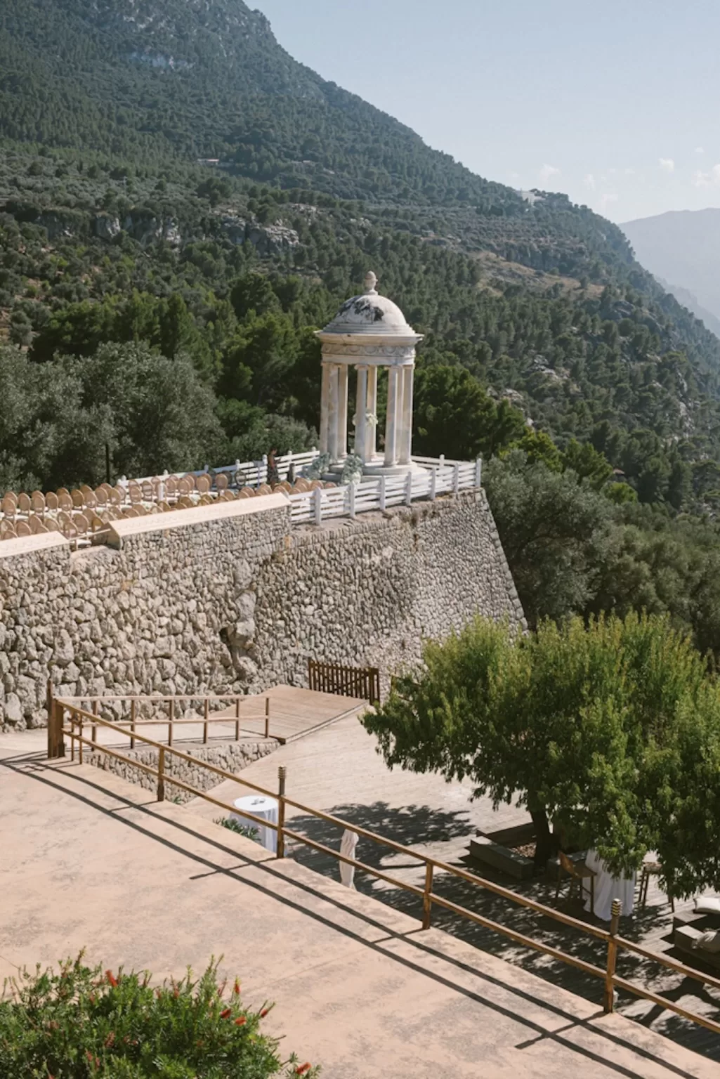 View of Son Marroig’s marble pavilion perched on the cliffside surrounded by lush mountains and sea.