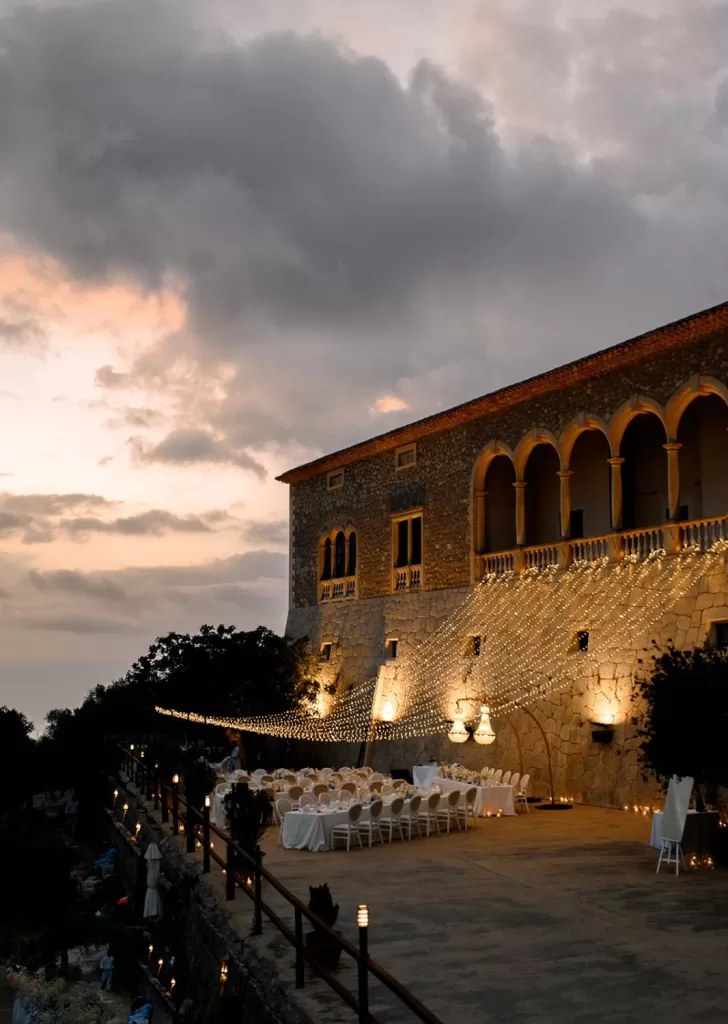 Evening reception setup at Son Marroig with romantic fairy lights draped across the historic stone courtyard.