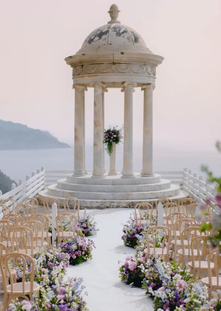 Low floral arrangements in soft purples and whites create a romantic path at Son Marroig.