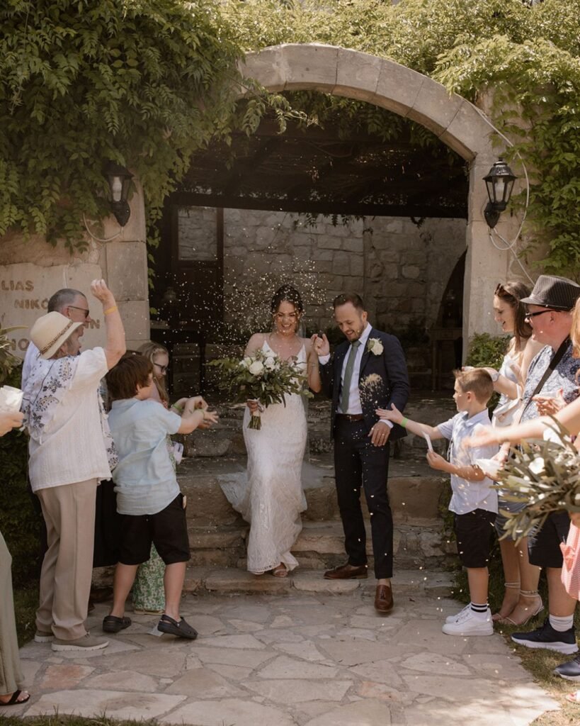 Intimate outdoor wedding ceremony at Vasilias Nikoklis Inn, with rustic wooden chairs and a floral arch under the Cyprus sun.