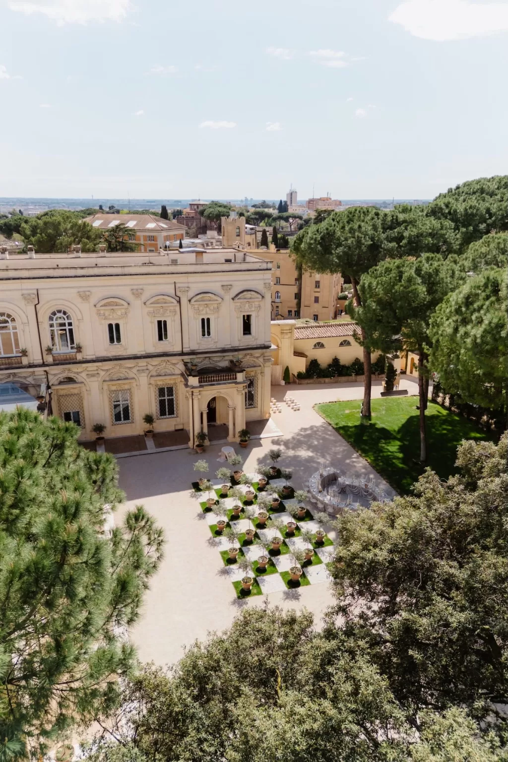 Aerial view of Villa Aurelia with checkerboard olive garden and manicured lawn