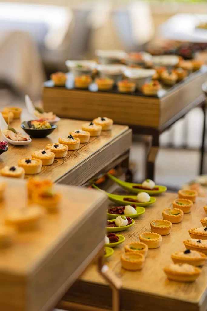 Elegant wedding canapés on wooden trays during cocktail hour at Villa Cariola.