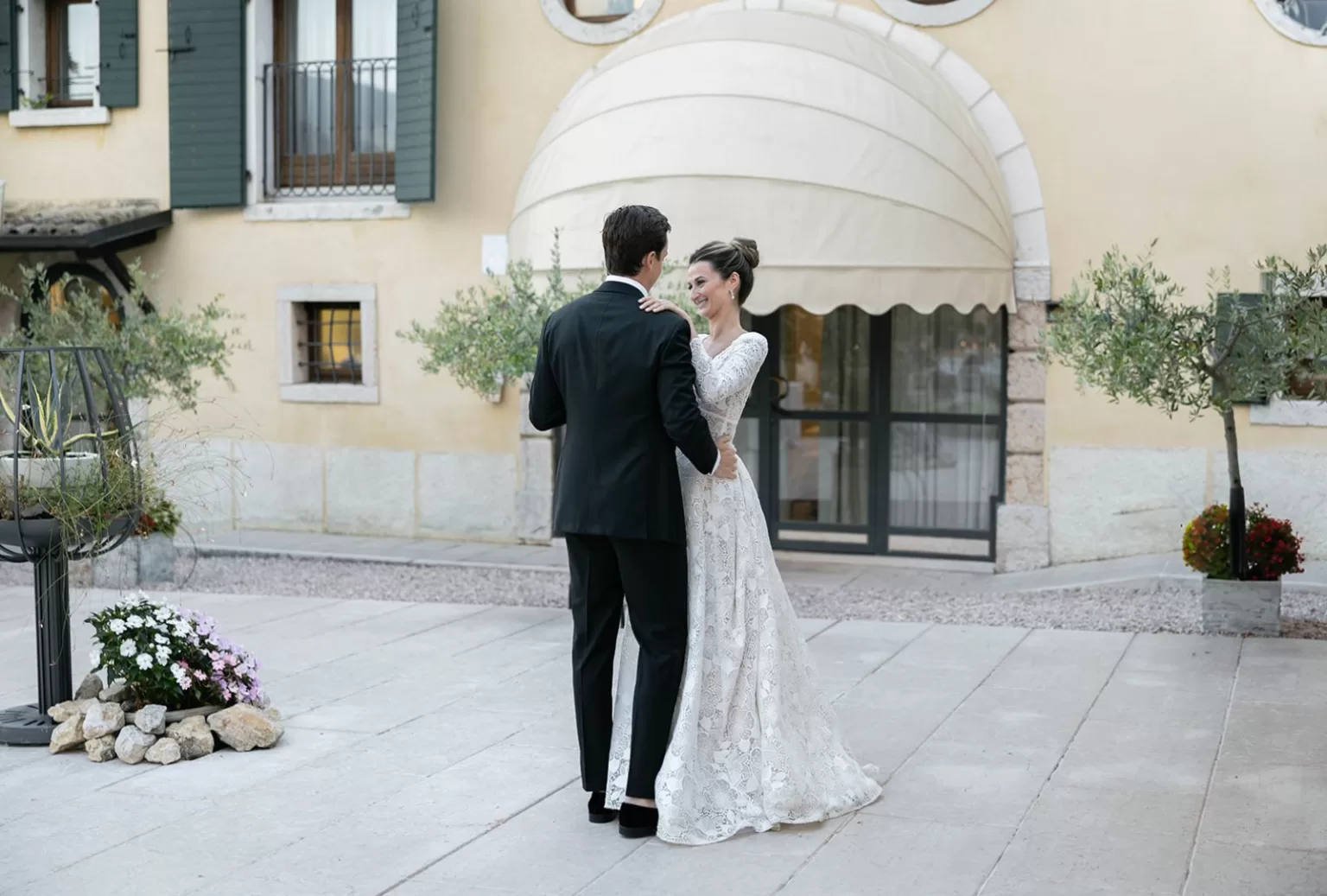 The newlyweds share their first dance outdoors at Villa Cariolla as guests look on with joy.
