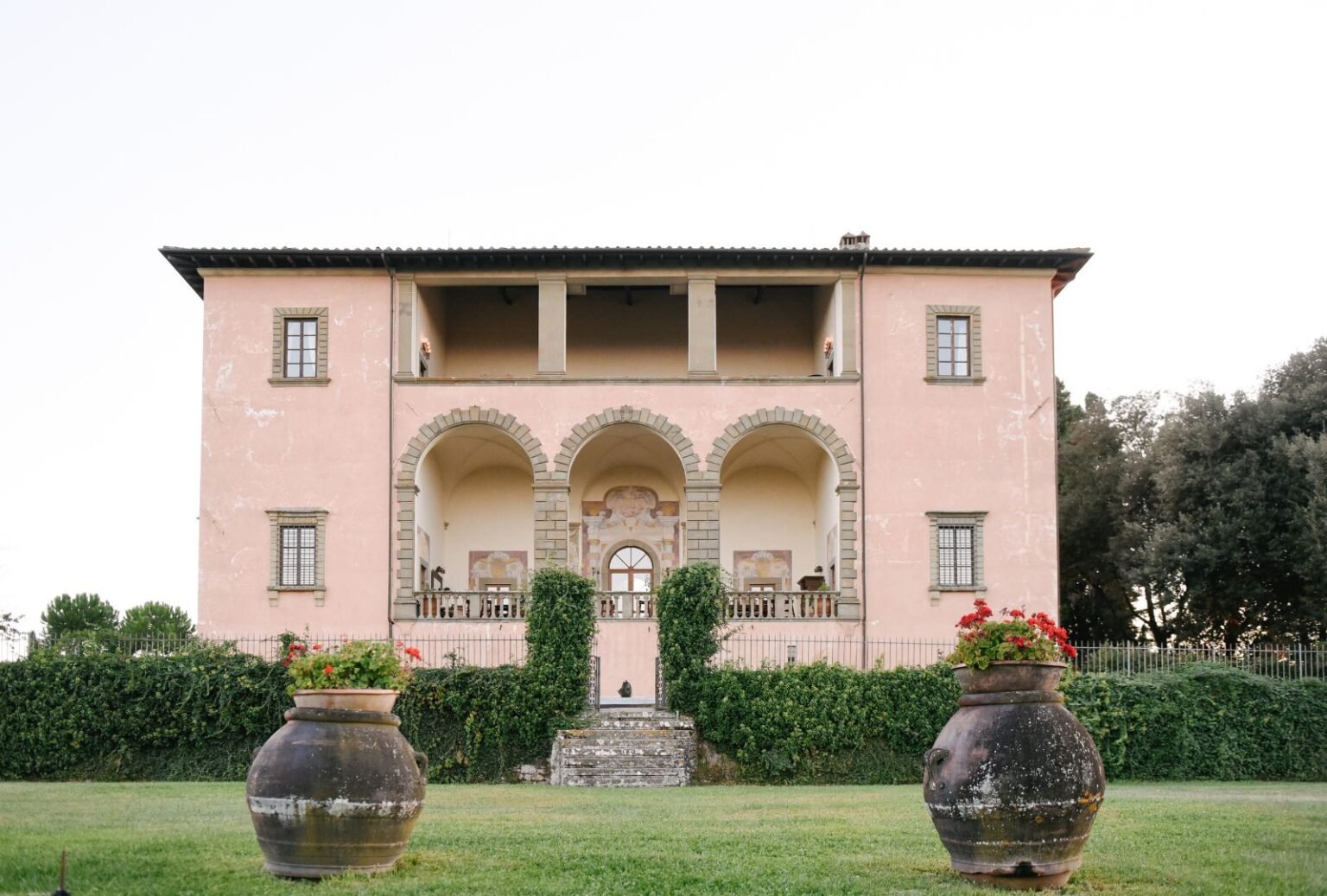The majestic facade of Villa Mangiacane showcasing its Italian architecture and historic charm, surrounded by lush gardens