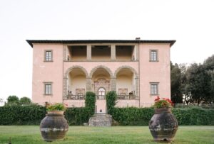The majestic facade of Villa Mangiacane showcasing its Italian architecture and historic charm, surrounded by lush gardens