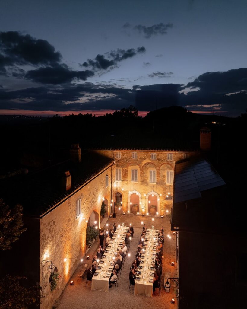 The picturesque Borgo Sant Ambrogio courtyard at night, beautifully lit for a romantic wedding atmosphere, captured by D2 Photography.