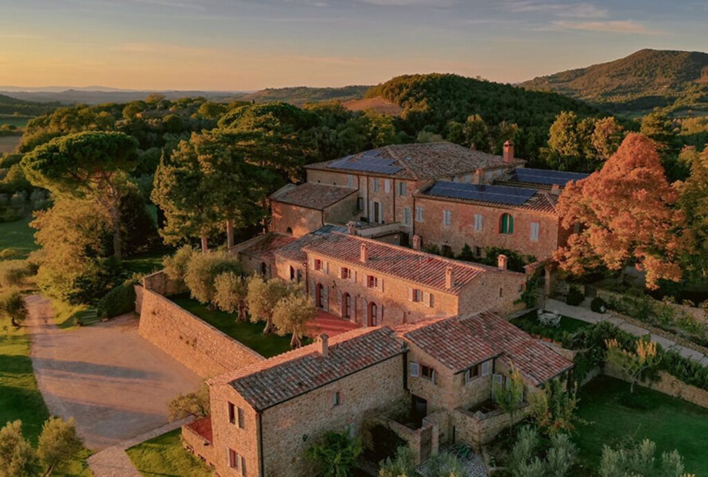 A panoramic view of Borgo Sant'Ambrogio, showcasing the historic stone buildings and lush gardens in the Tuscan countryside.