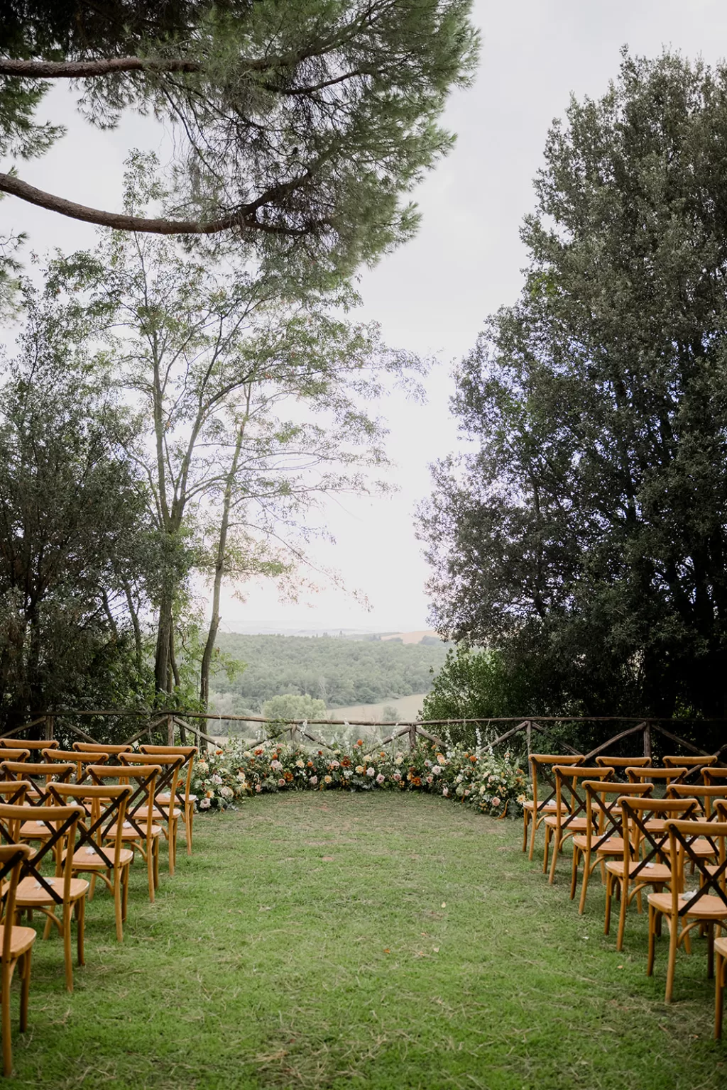 Trees arching above a countryside ceremony spot at Borgo Sant'Ambrogio, creating a natural, romantic canopy.