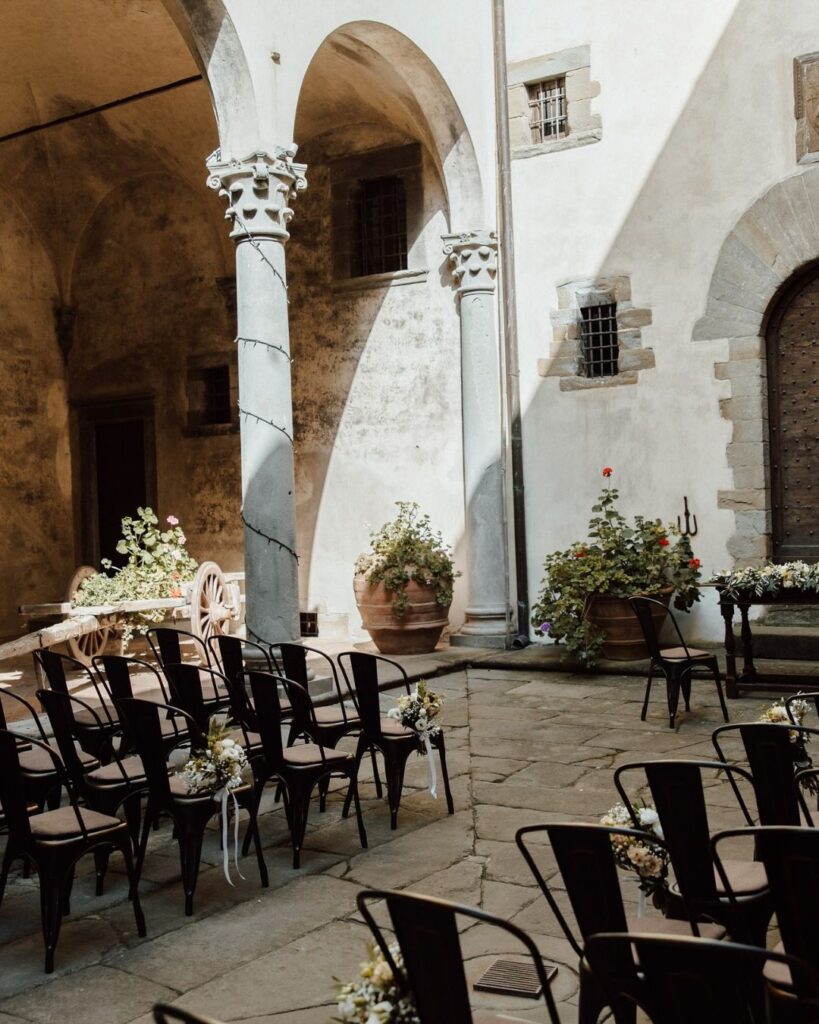 Exquisite wedding decor centerpieces at a reception in Castello del Trebbio, Italy.