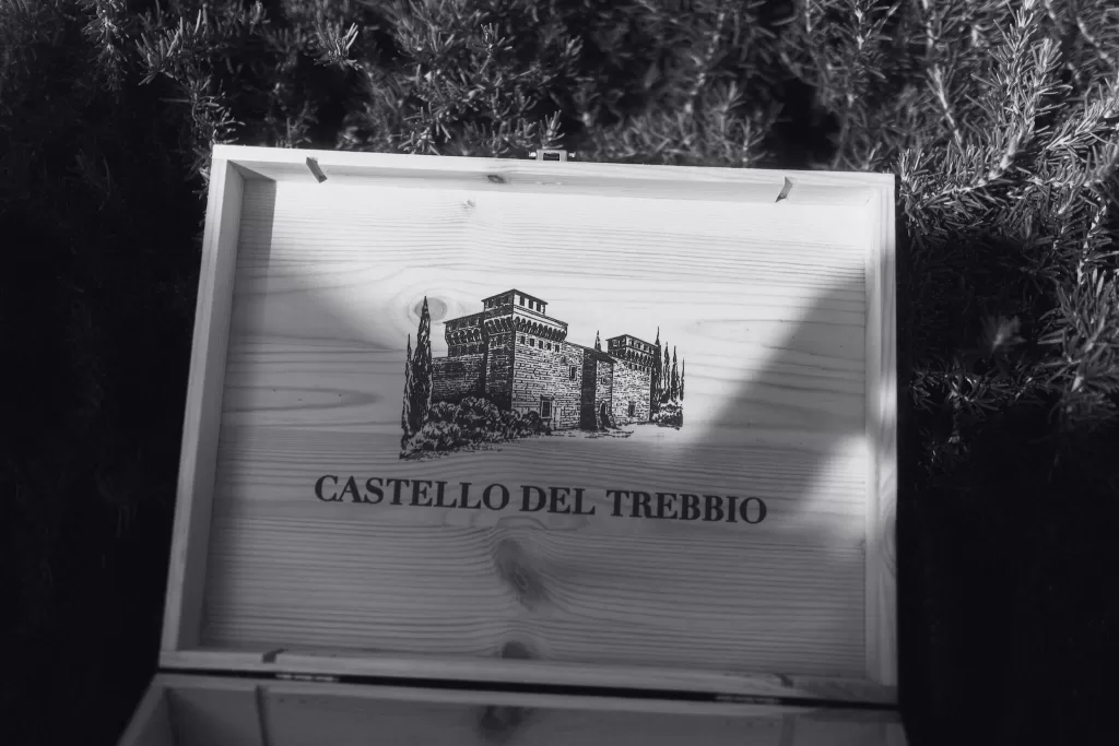 Wooden wine box engraved with Castello del Trebbio illustration, symbolizing the venue’s heritage.