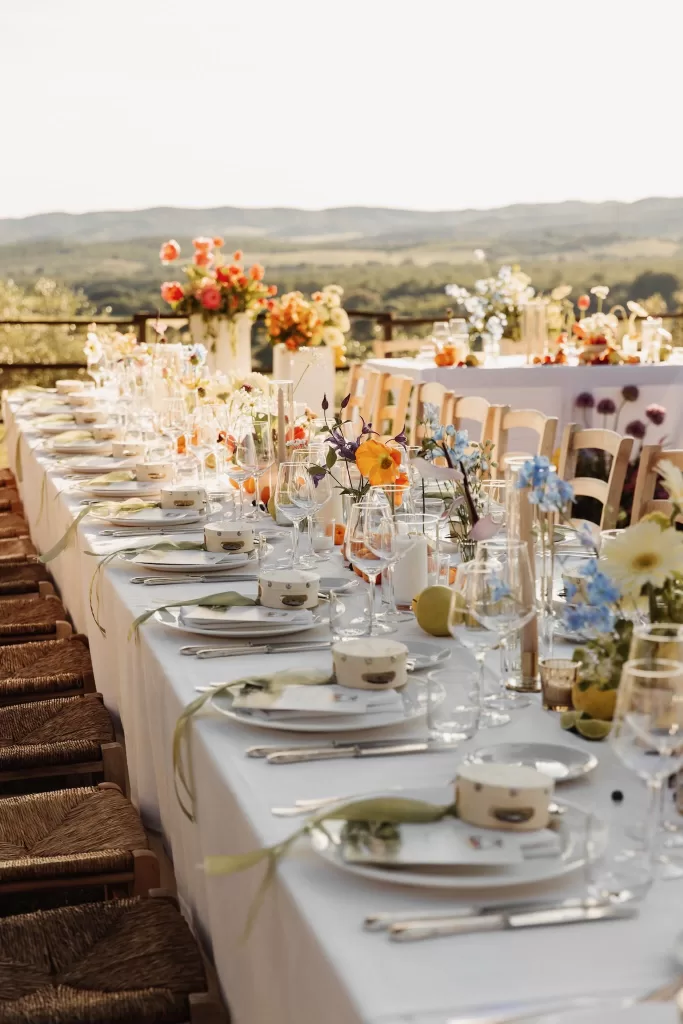 Elegant tablescape with citrus fruit, ribbons, and pastel florals overlooking the vineyard at Conti di San Bonifacio.