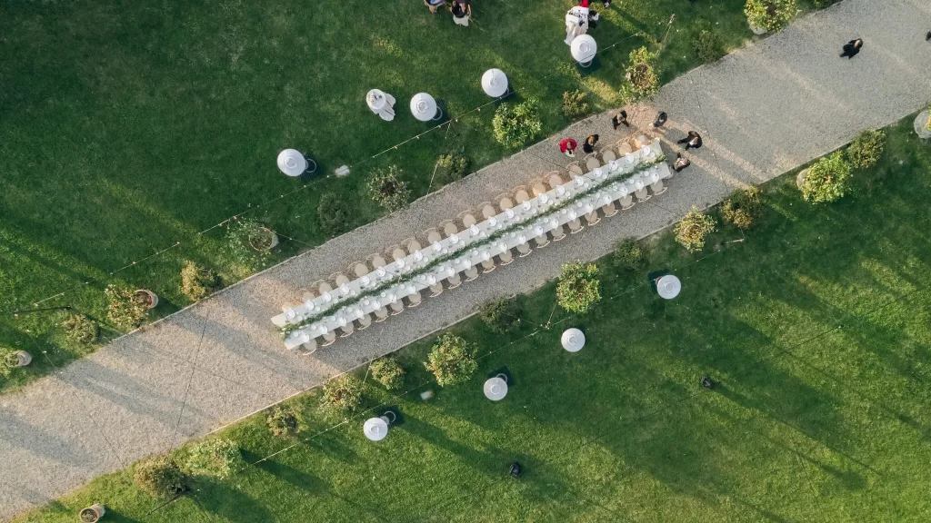 Aerial view of the long outdoor wedding table setup at Villa Medicea di Lilliano, perfectly aligned along the garden path.