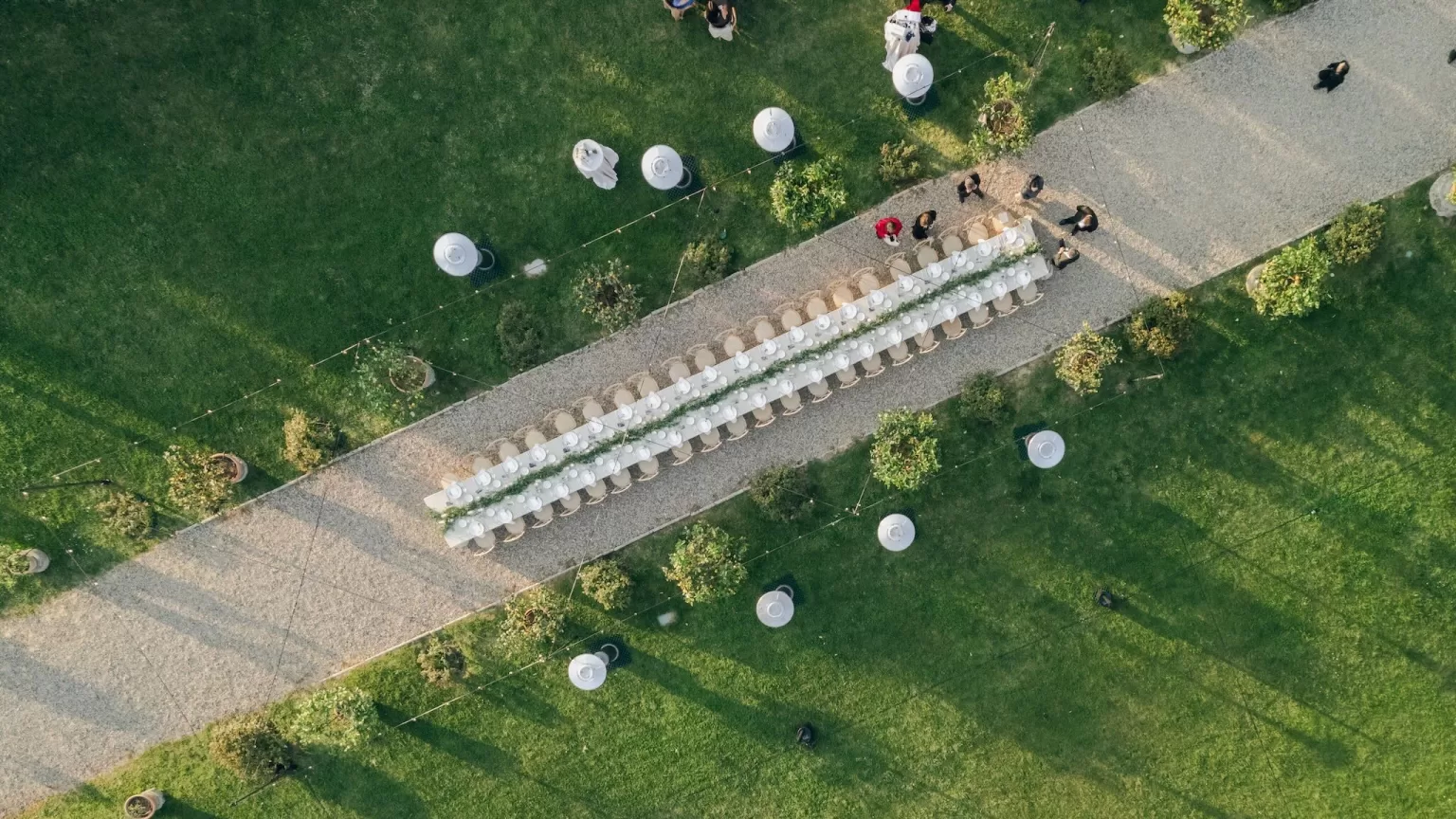 Aerial view of the long outdoor wedding table setup at Villa Medicea di Lilliano, perfectly aligned along the garden path.