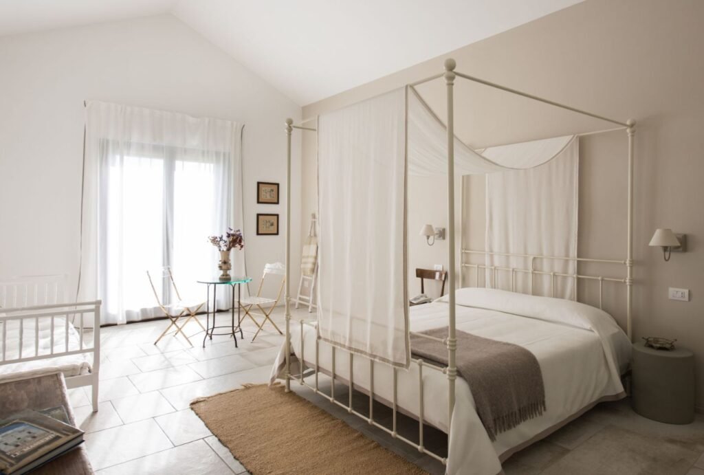 Spacious bridal suite interior at Masseria Fontana di Vite in Italy, featuring vintage furniture and luxurious finishes.