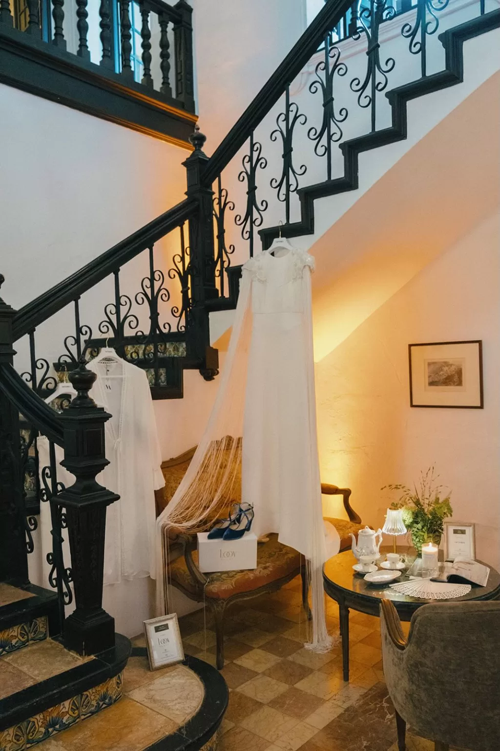 Bridal gown and accessories styled in vintage stairwell corner at Masia Aldamar