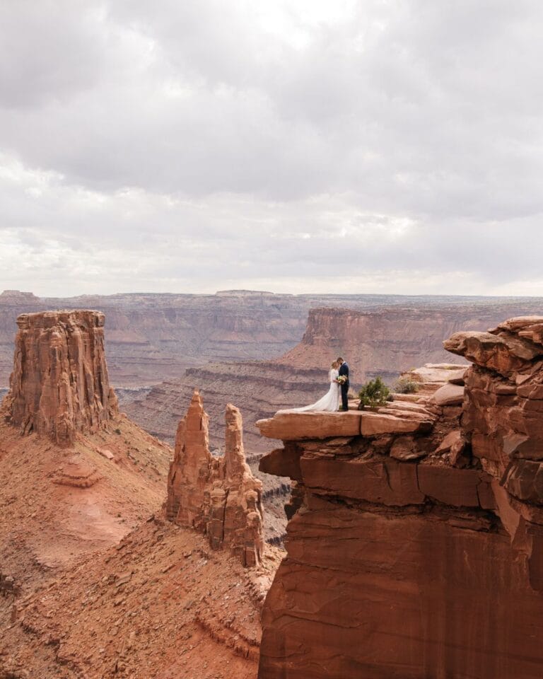 Bride and groom enjoying breathtaking mountain views at Whispering Oaks Ranch, photographed by Kayla Bertagnolli.