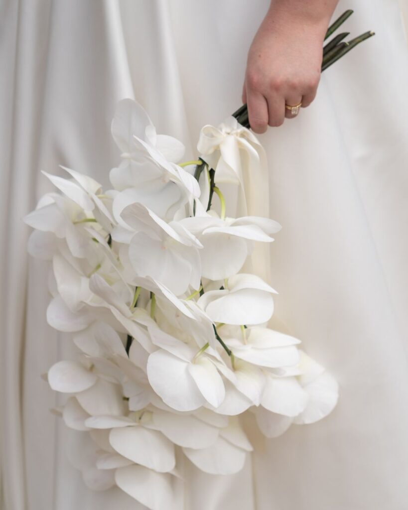 A close-up of a lush bridal bouquet filled with soft pastel blooms, captured by Bella Weddings.