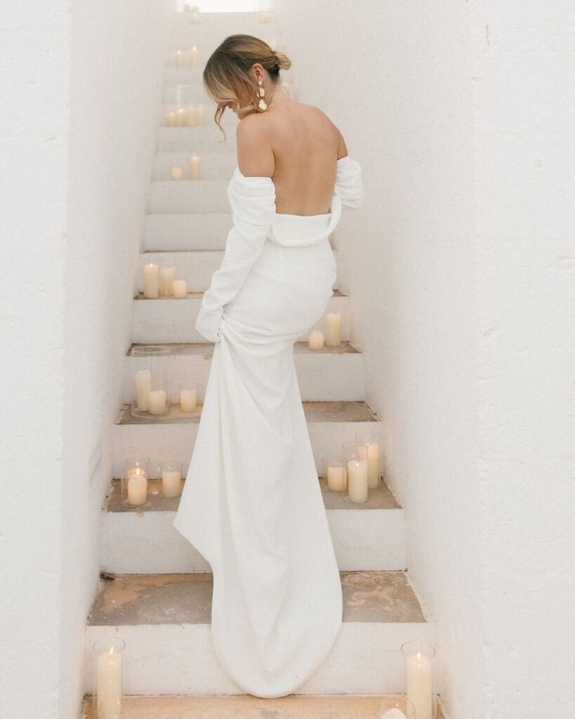 A bride walking through the serene white stone pathways of Masseria Morosetta, capturing the venue’s timeless elegance and Mediterranean charm.