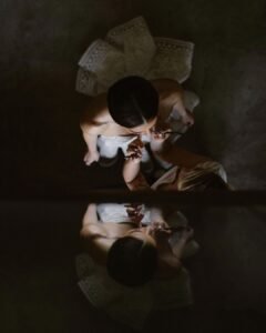 An artistic overhead portrait of the bride at Areias do Seixo, capturing the soft elegance of her gown and delicate details.