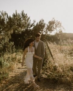 A windswept moment on the beach as the bride’s dress flows in the breeze, creating a dreamy and cinematic scene.