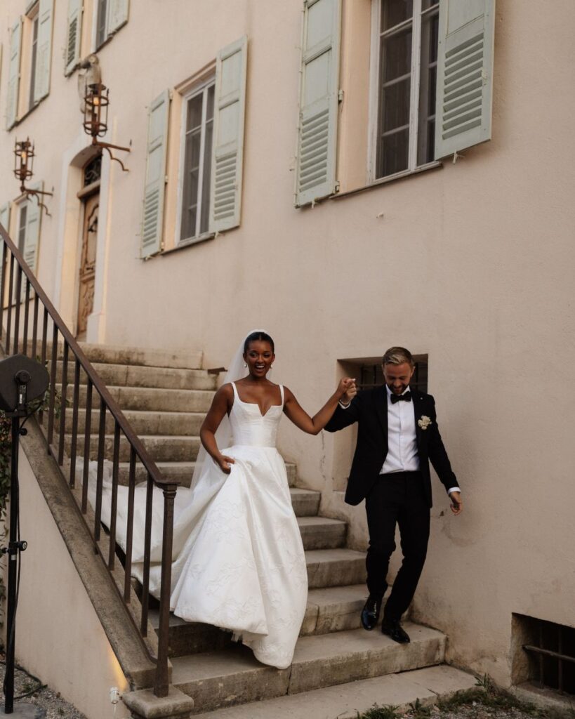 Bride and groom descending the stone steps of Bastide du Roy, capturing an elegant and timeless wedding moment