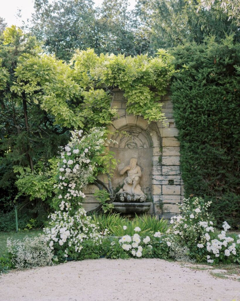 Wisteria draping over the stone walls of Bastide du Roy, adding a touch of romance to the venue.